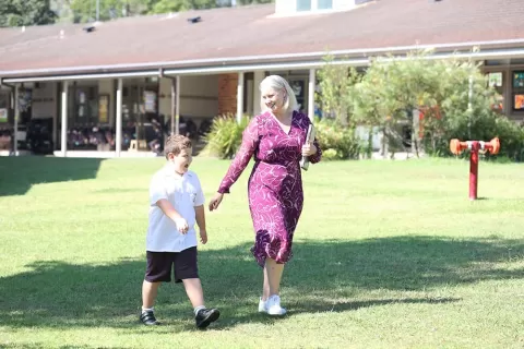 Fiona and Leo walking on school grounds