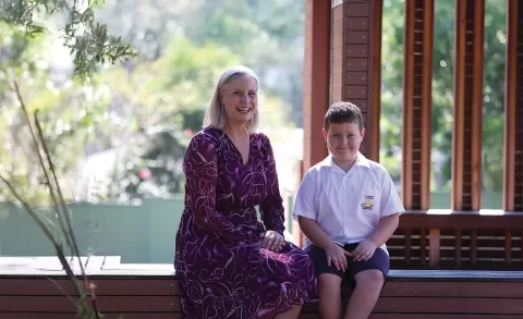 Eileen and Leo sitting in a school