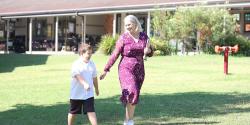 Fiona and Leo walking on school grounds