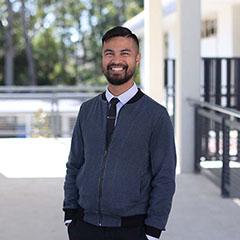 Teacher standing and smiling